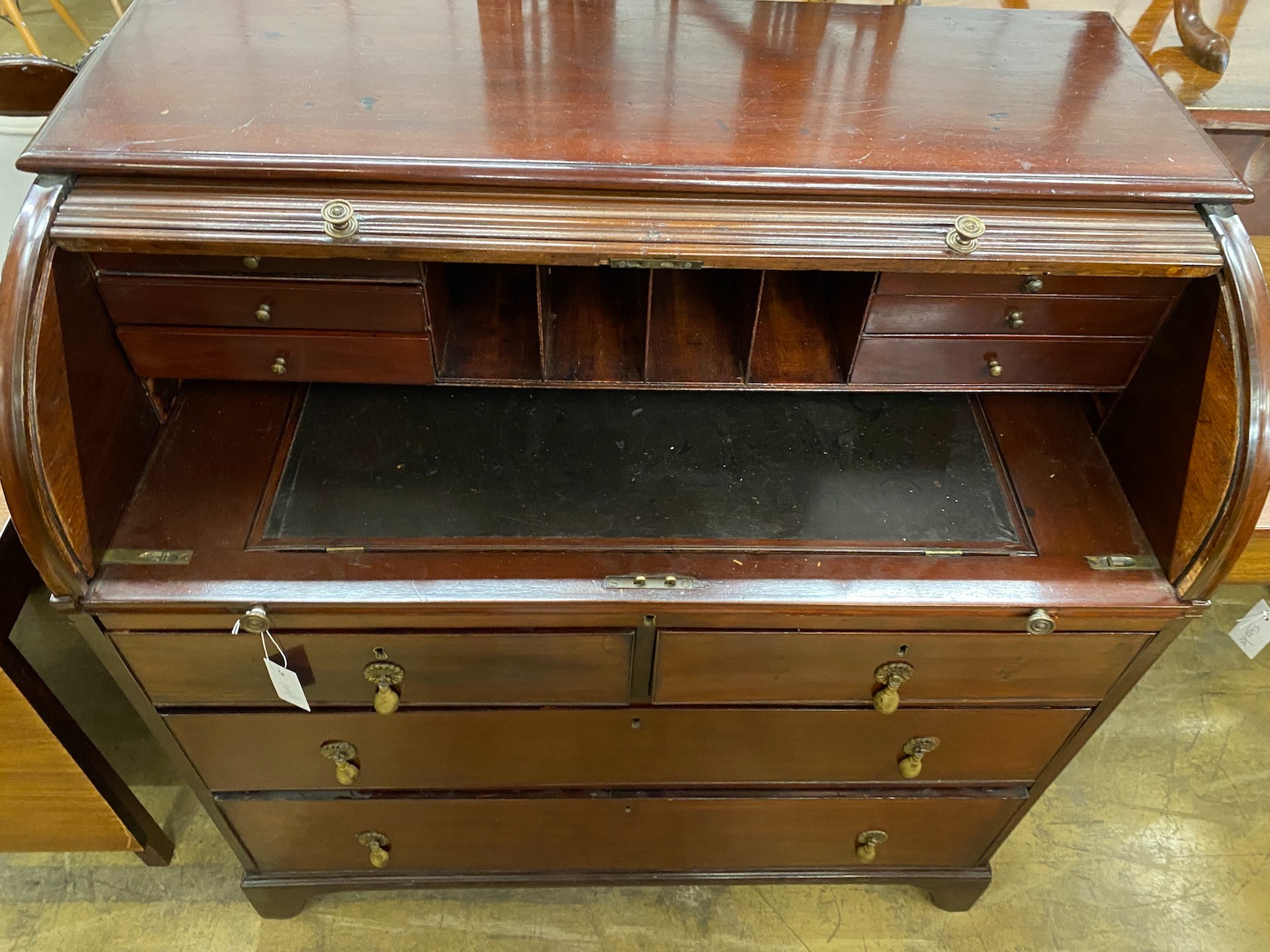 A George IV mahogany tambour cylinder bureau fitted four drawers, width 102cm, depth 57cm, height 105cm.